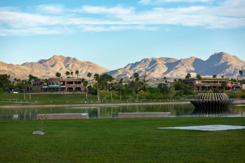 mountains surround a lake in a small city park