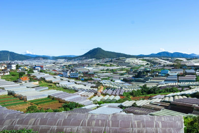 many houses that are built in rows with mountains behind them