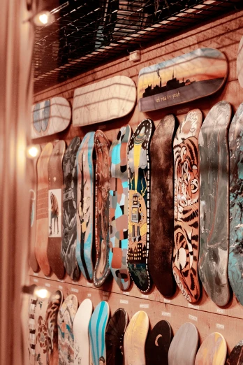 an assortment of skateboards mounted on a shelf