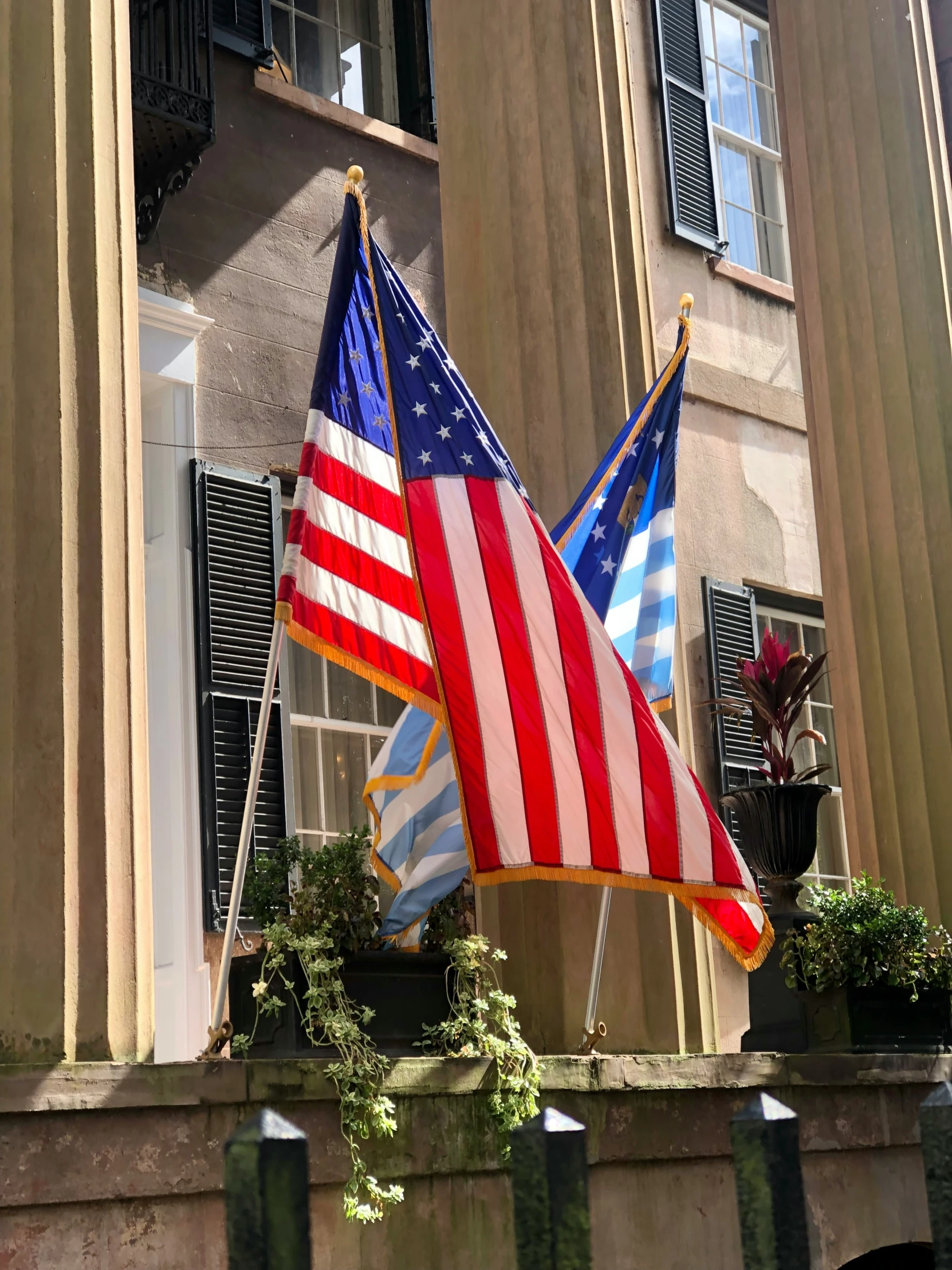 two flags next to each other on the ledge