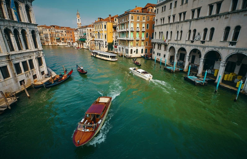 boats on the water passing through a city