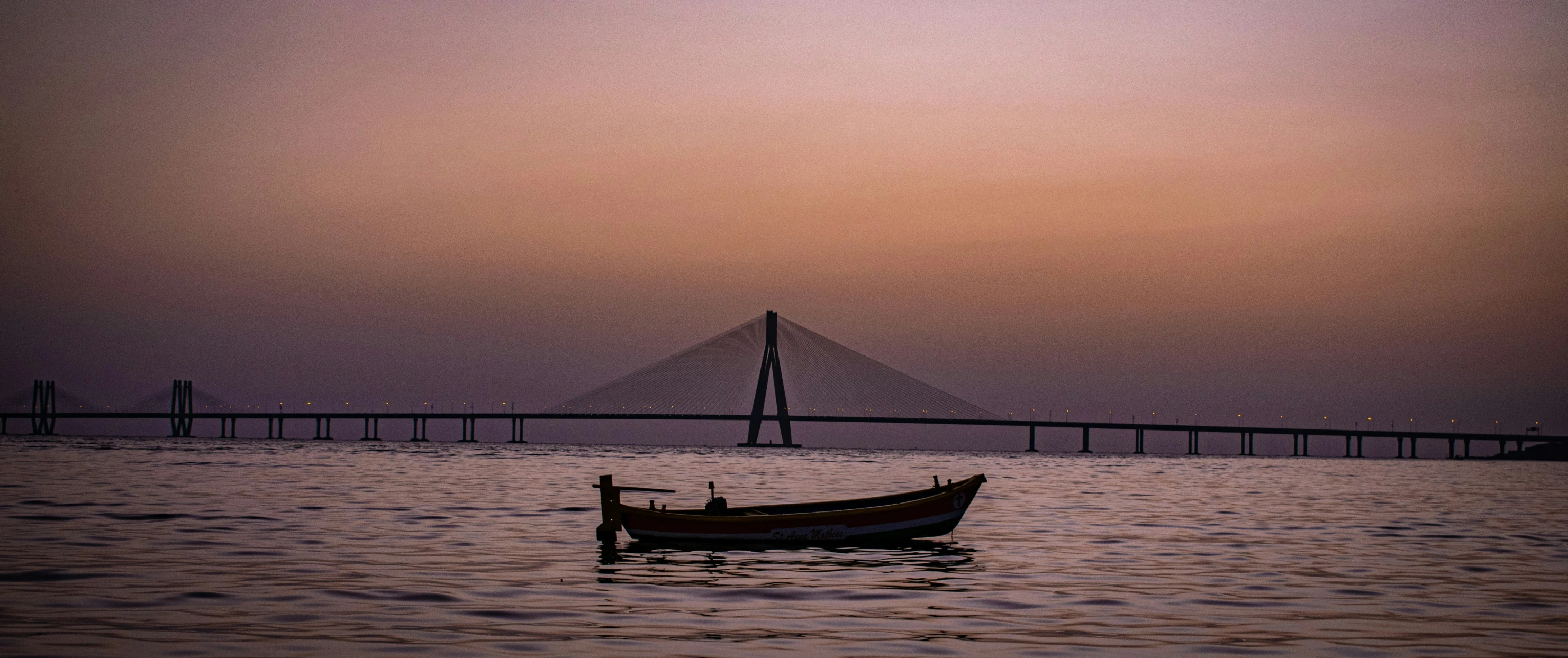 a boat is floating in a calm harbor