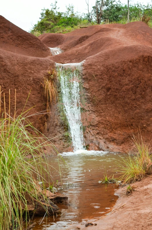 a waterfall that is partially submerged in the ground