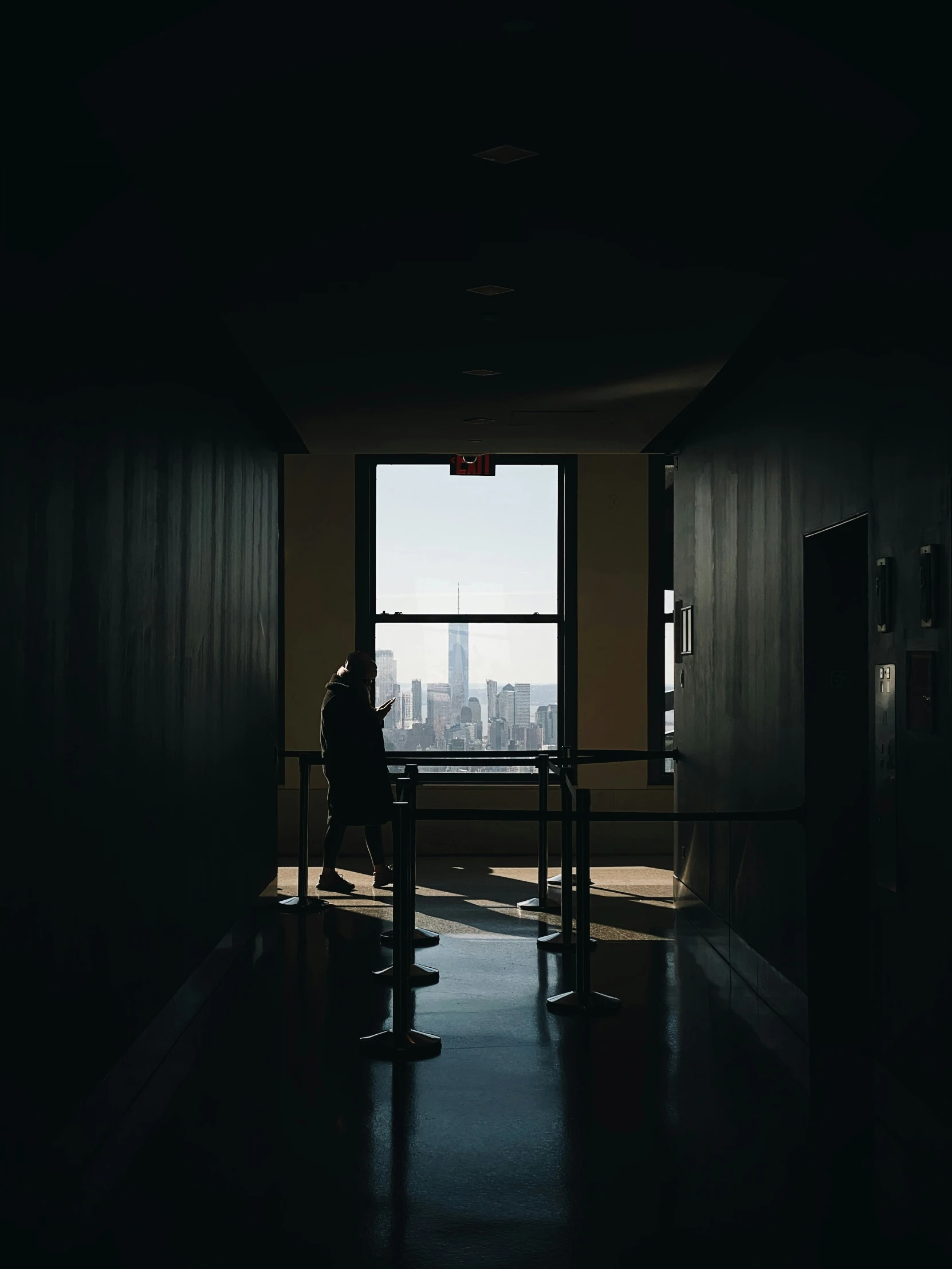 a man sitting on top of a bench next to a window