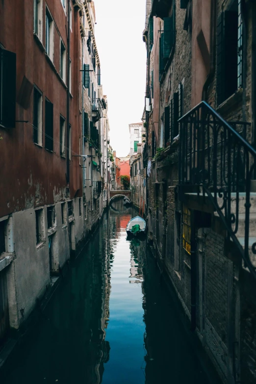 boat on waterway in city canal with buildings in background