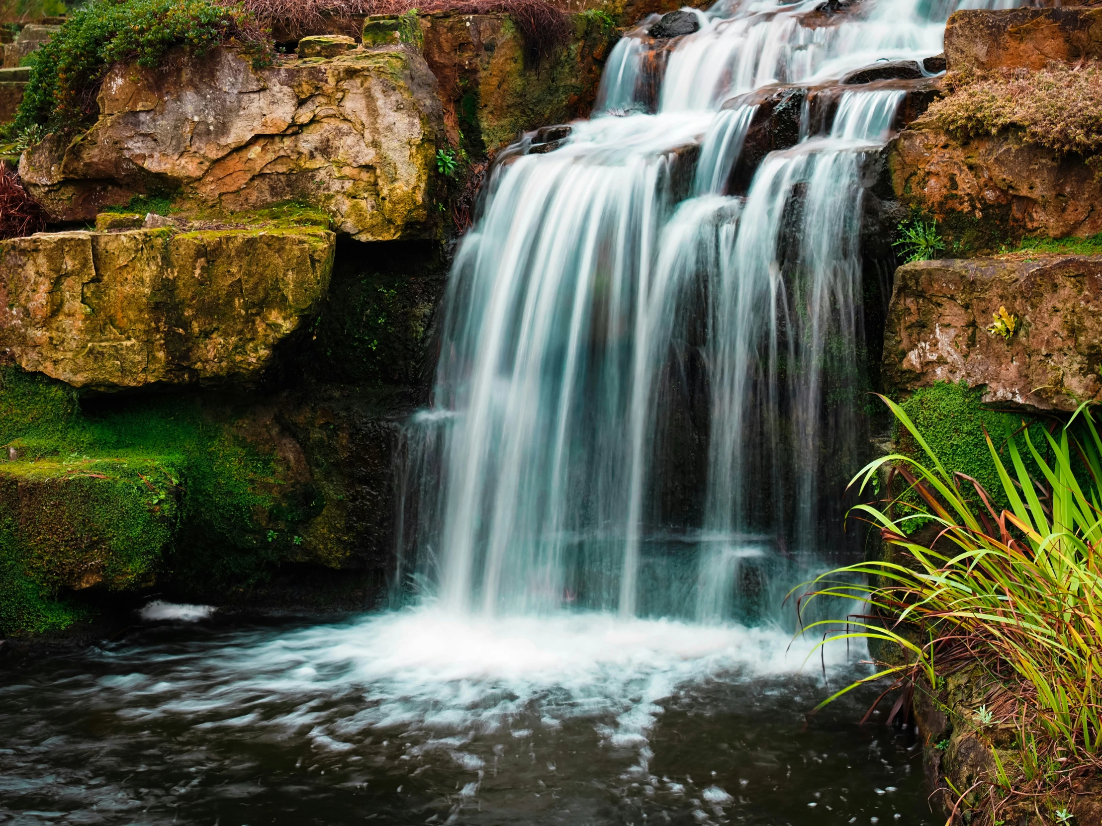 there is water going down a small waterfall