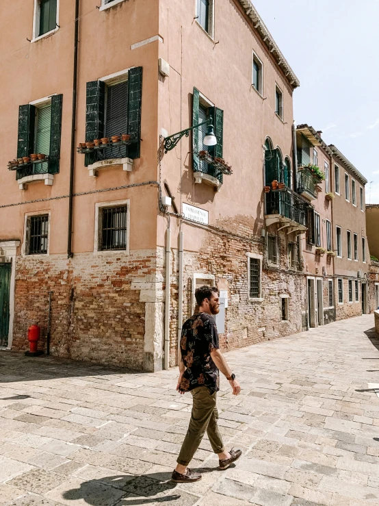 a man is walking around in a small courtyard area