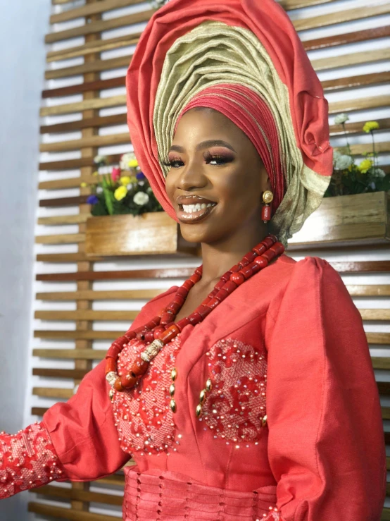 a black woman in a red and green african dress