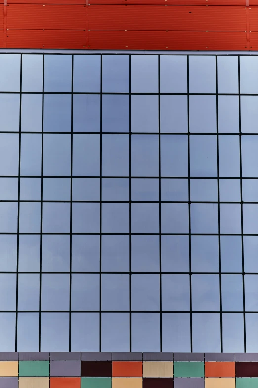 a tall brick building reflected in colorful tiles