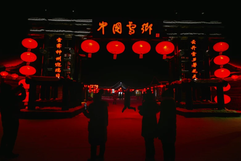 people standing under an archway with lots of lights