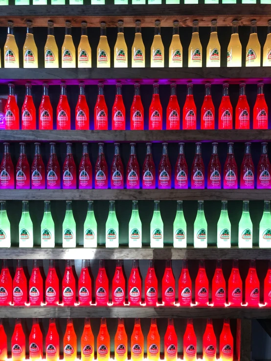 brightly lit bottles on display in front of a window