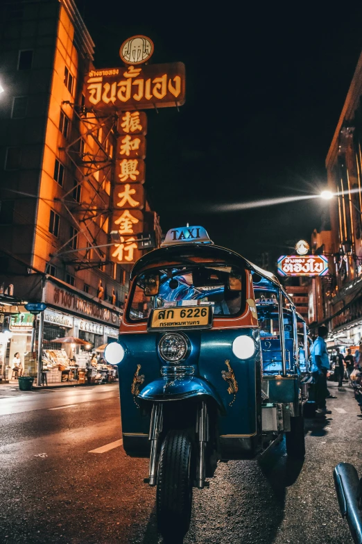 cars are parked near the side of the road at night