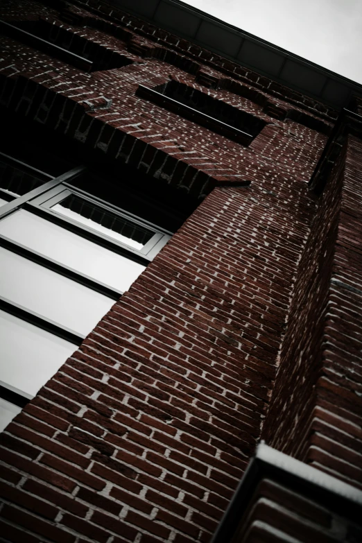 a brick building with two windows and several large windows