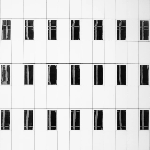 a black and white po of windows with shutters