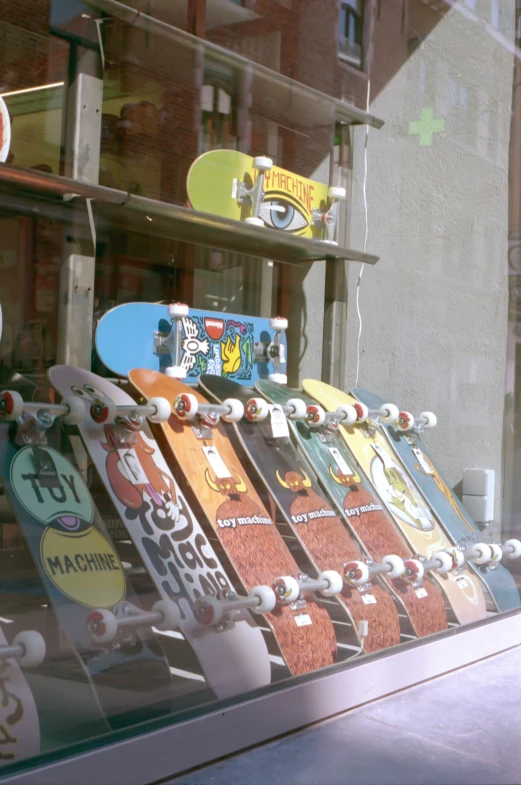 the row of skateboards is displayed on the window