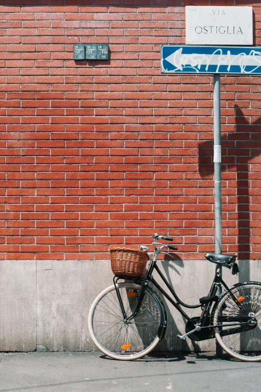 the bike is  up against the street sign