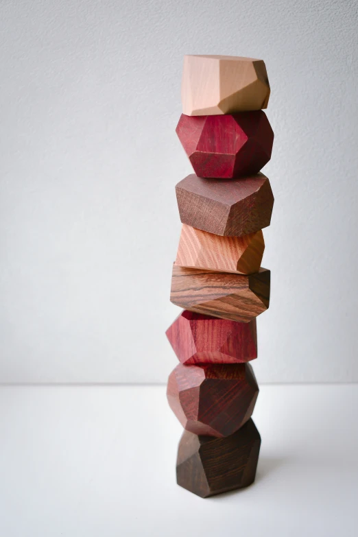 three wooden blocks stacked next to each other on a white surface