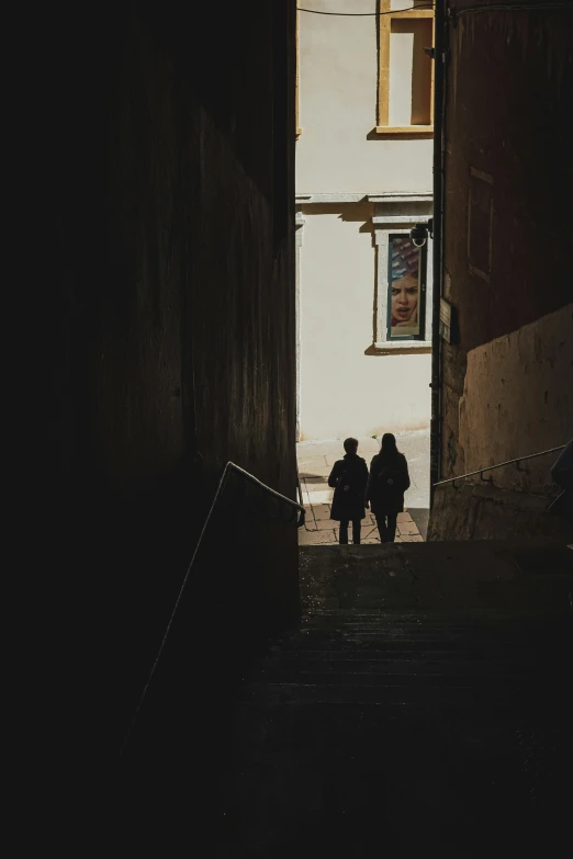 two people are sitting under an open door