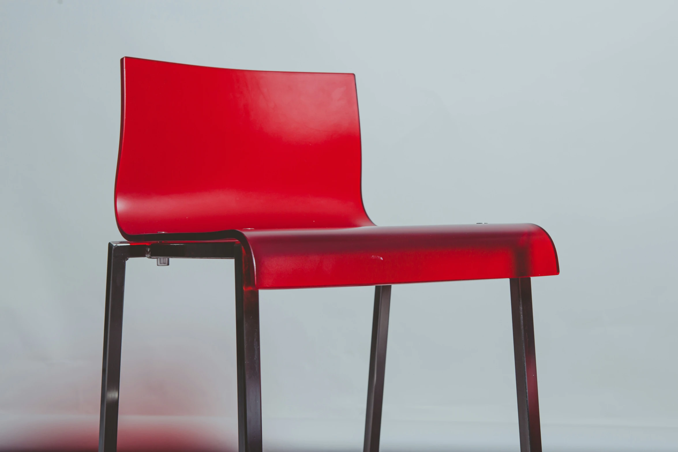 a red leather chair against a grey background