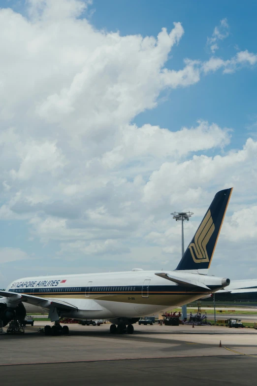 large jetliner on runway with airplane in the background