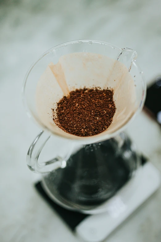 an empty cocktail cup sitting on a counter with a beverage filterer