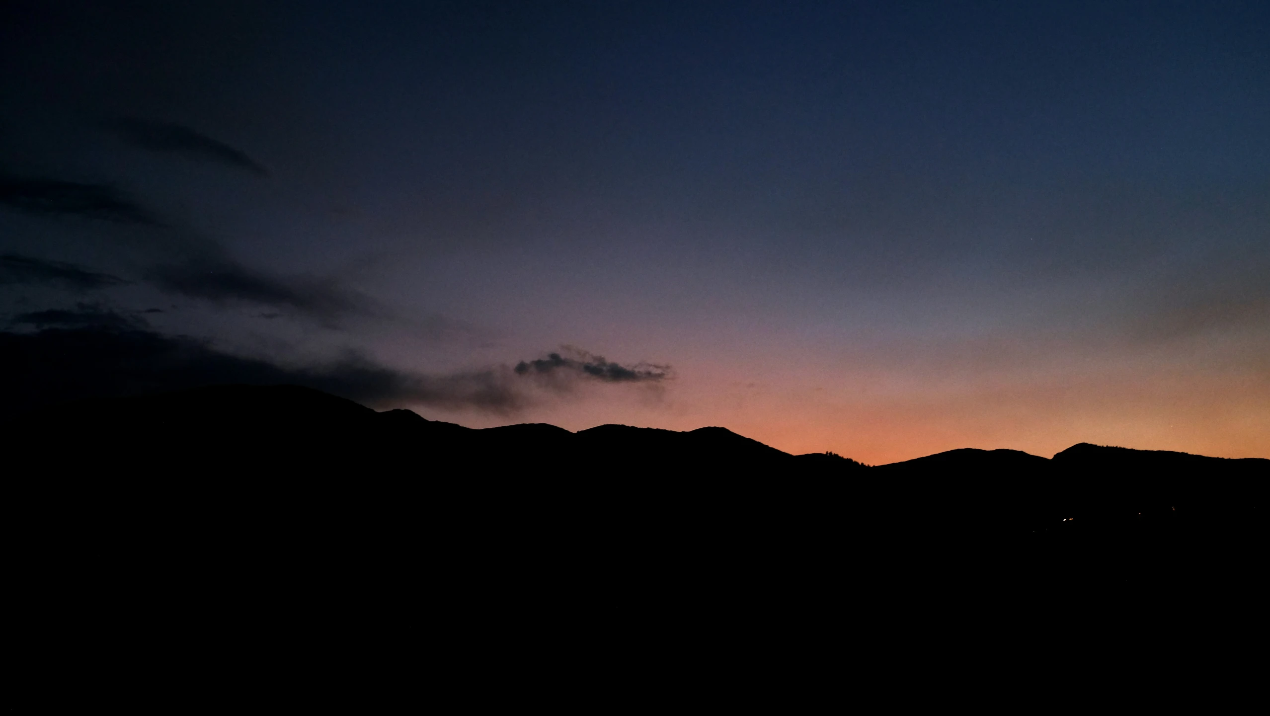 a picture taken at night with mountains in the background