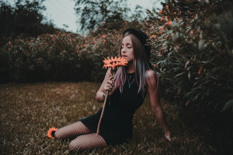 a woman with long hair wearing a dress and holding flowers in her hands