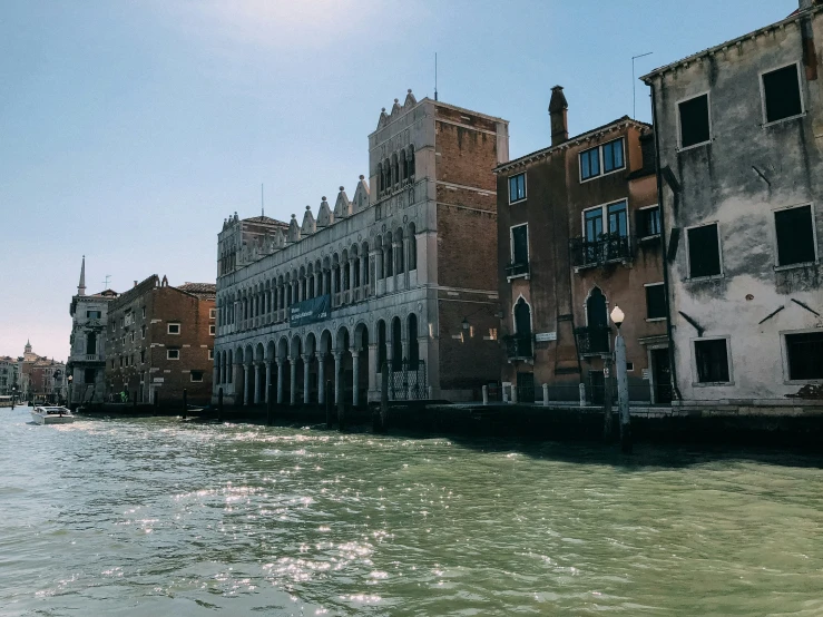 old buildings sit along the edge of a body of water