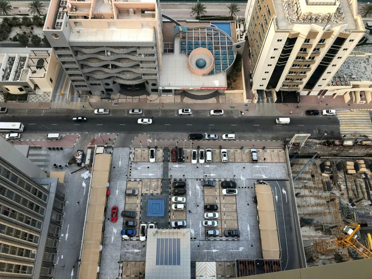 an aerial view of a parking lot with buildings on each side