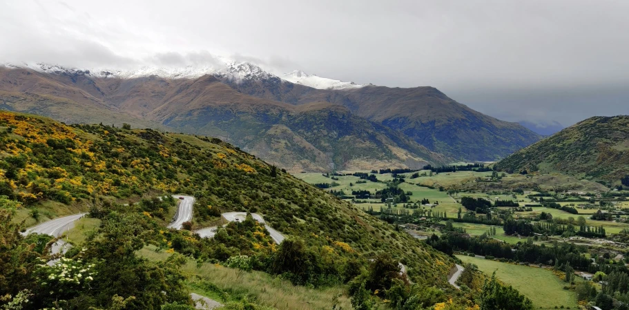 a scenic valley scene with a road running through it