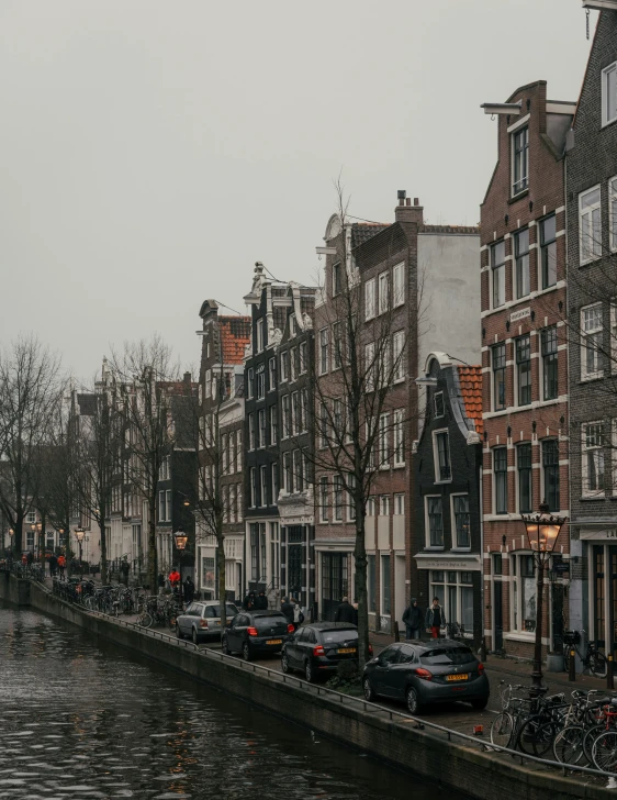 a row of buildings on a street with bicycles in front of them