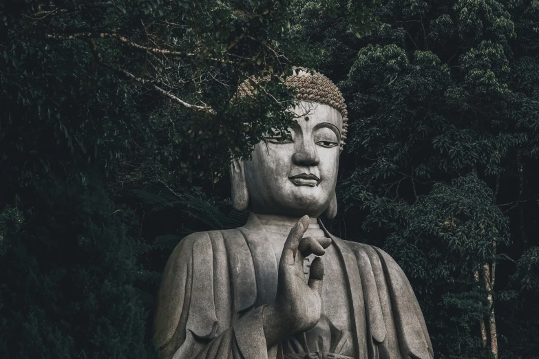 the large buddha statue has a small dog on his lap