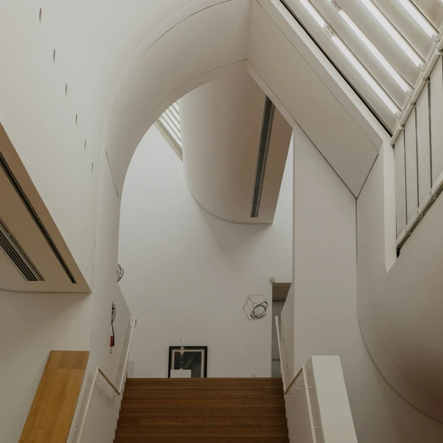 an airy hallway has stairs to the ceiling