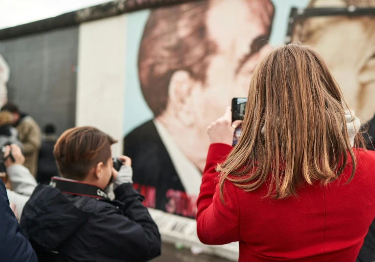 two people take pictures as others look at them