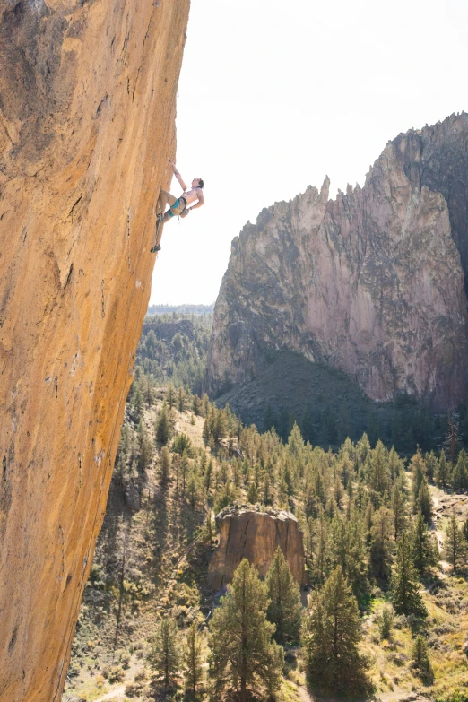 a person climbing down the side of a very tall mountain