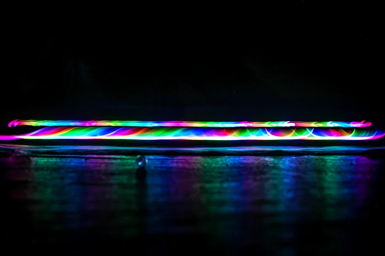 a glowing tube floating on top of water