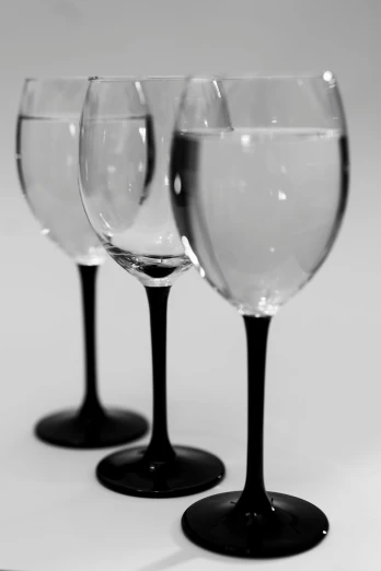 a group of three wine glasses next to each other
