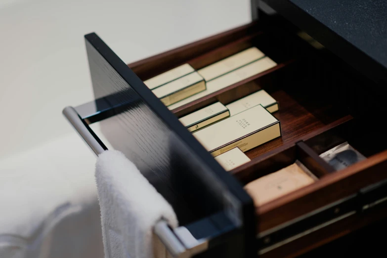 an open filing cabinet with many books