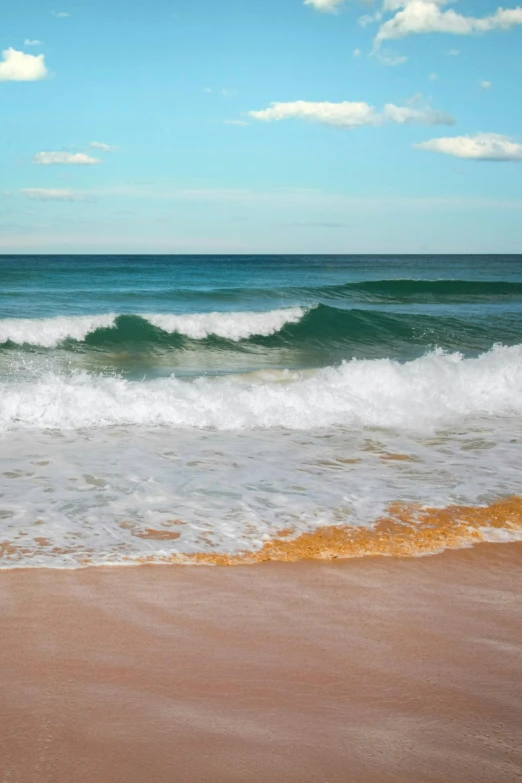 a view of some water and waves from the sand