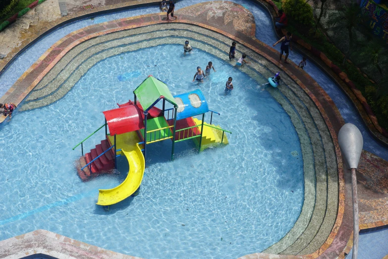 this is an overhead view of a large pool with a playground in it