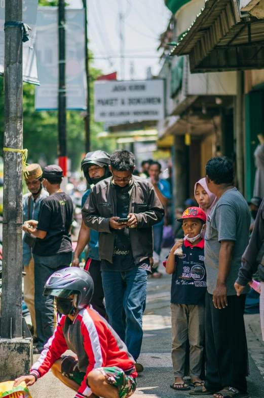 a man in motorcycle attire and some children