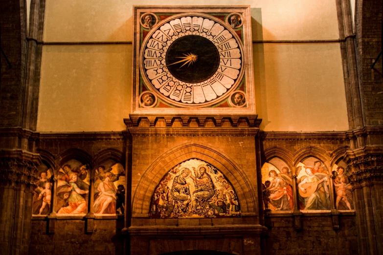 a clock and some statues in a large building