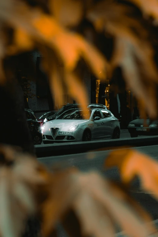 two cars parked on the side of a road next to tall buildings