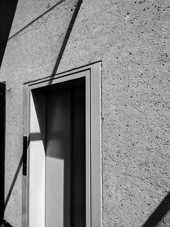 black and white pograph of the shadow of the door