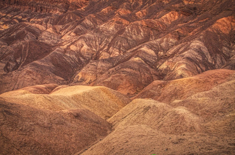 an aerial view of hills and valleys near the ocean