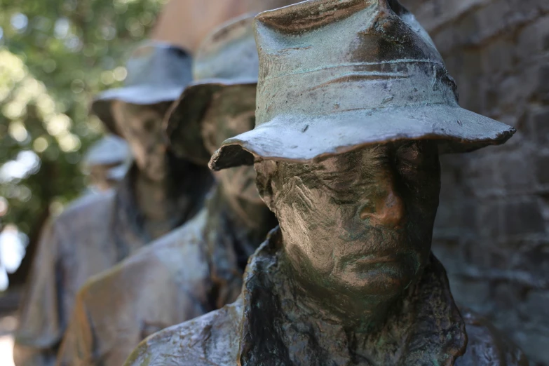 a group of statues in hats standing next to each other