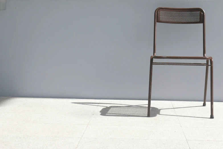 a chair is casting a shadow on the floor