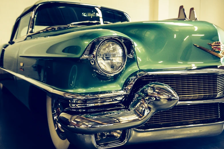 an old car with shiny metal trim sits parked