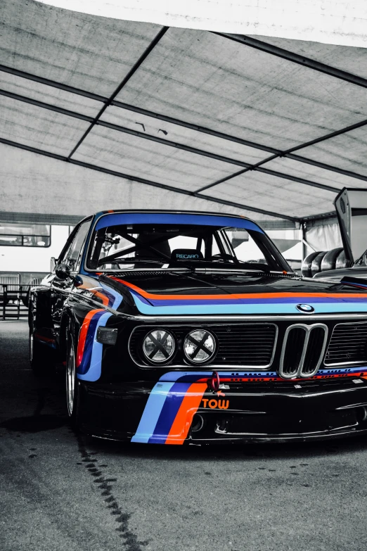 an antique black and white po shows a painted bmw