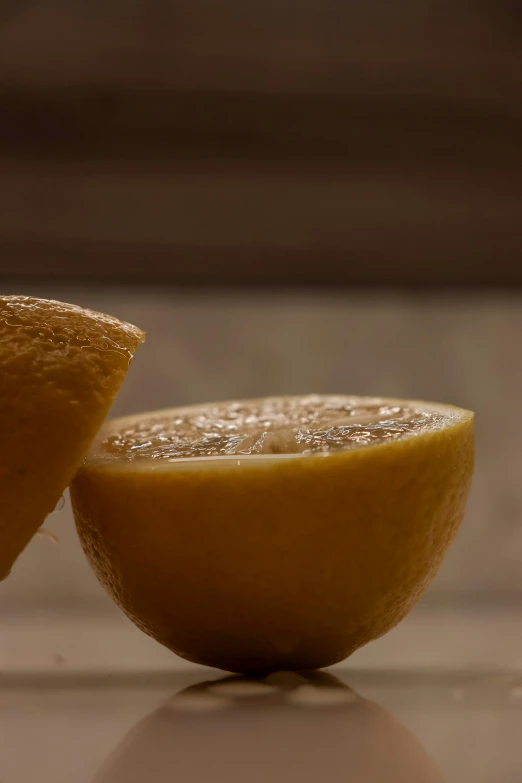 an orange with two pieces of it and one cut in half